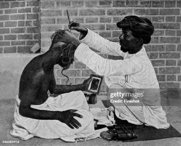 Historical Geography. 1900. India. Highly esteemed among all visitors to the compound is the native barber, who retails the latest gossip from the...