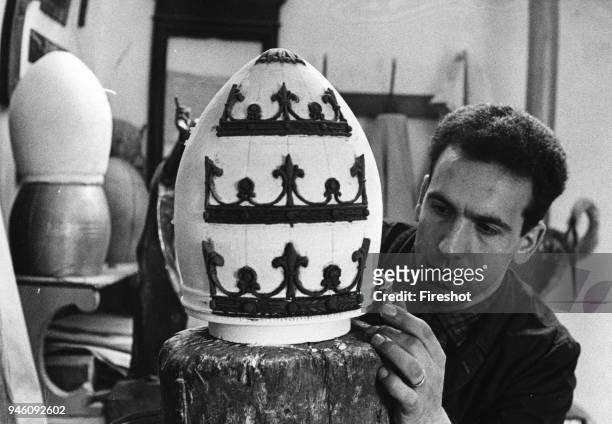 Bergamo April 1959 The sculptor Attilio Nani with her sons workin on the tiara that the provincial government will offer to Pope John XXIII May 2,...