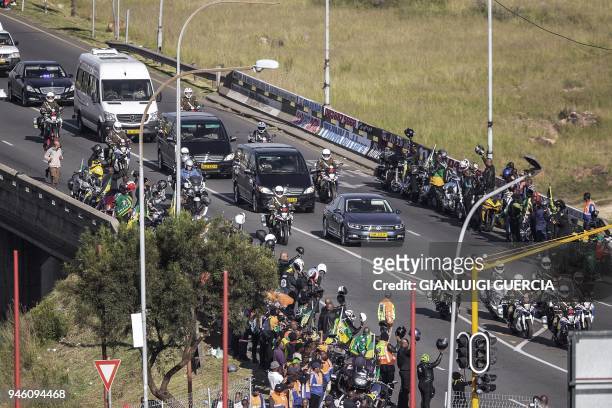 The motorcade transporting the coffin of Winnie Madikizela-Mandela drives through Soweto after leaving her home towards Orlando Stadium for a funeral...