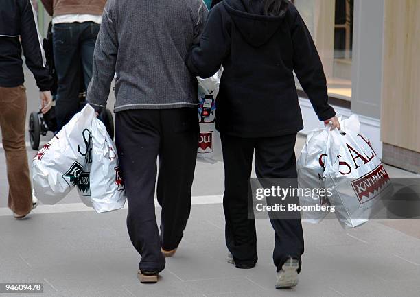 Shoppers carrying bags stroll through a shopping mall in Sylvia Park, Auckland, New Zealand, on Tuesday, June 26, 2007. New Zealand's retail sales...