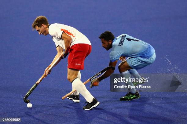 Harry Martin of England and Harmanpreet Singh of India in action in the Men's bronze medal match between England and India during Hockey on day 10 of...