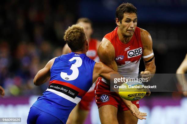 Josh P. Kennedy of the Swans handpasses the ball during the round four AFL match between the Western Bulldogs and the Sydney Swans at Etihad Stadium...