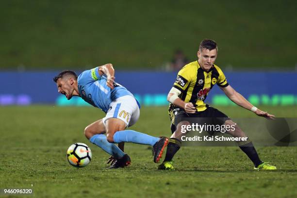 Dario Vidosic of Melbourne City is tackled by Scott Galloway of the Phoenix during the round 27 A-League match between the Wellington Phoenix and...