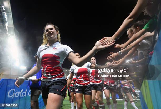 Abigail Brown of England high fives young supporters following the Rugby Sevens Women's Pool B match between England and Wales on day 10 of the Gold...