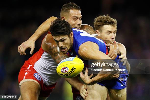 Easton Wood of the Bulldogs, Lance Franklin of the Swans and Luke Parker of the Swans contest the ball during the round four AFL match between the...
