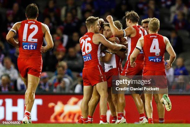 Swans players celebrate after winning the round four AFL match between the Western Bulldogs and the Sydney Swans at Etihad Stadium on April 14, 2018...