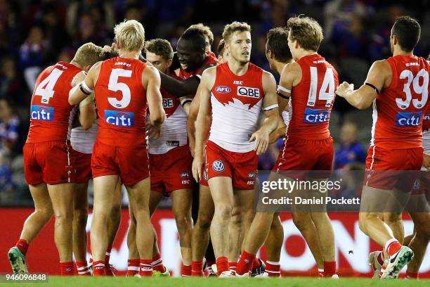 Swans players celebrate after winning the round four AFL match between the Western Bulldogs and the Sydney Swans at Etihad Stadium on April 14, 2018...