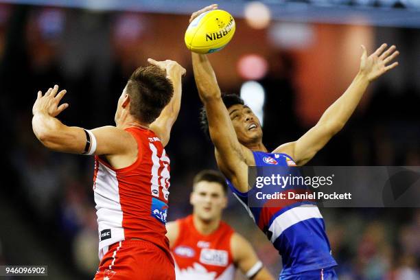 Lin Jong of the Bulldogs and Callum Sinclair of the Swans contest the ball during the round four AFL match between the Western Bulldogs and the...