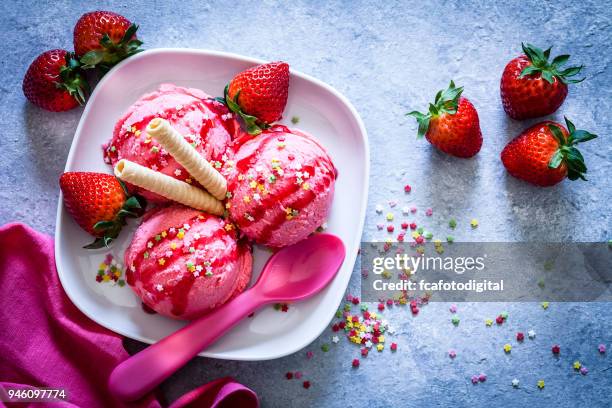 strawberry ice cream shot on garden table - strawberry syrup stock pictures, royalty-free photos & images