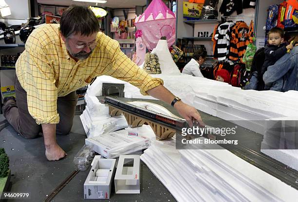 Ernst Porst of toyshop Puppenkoenig sets up a Maerklin train display in the store's shop window in Bonn, Germany, on Monday, October 16, 2006. The...