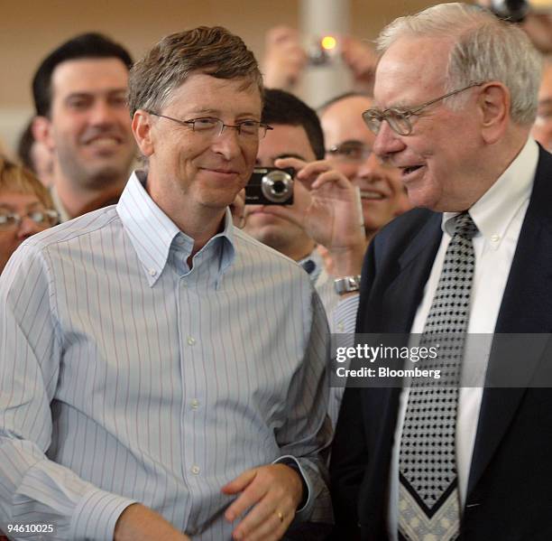 Berkshire Hathaway Inc. Chairman Warren Buffett, left, tries to talk Microsoft Corp. Chairman Bill Gates into playing Ariel Hsing in table tennis, as...