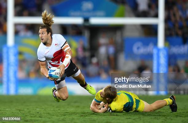 Daniel Bibby of England is tackled by Ben O'Donnell of Australia during the Rugby Sevens Men's Pool B match between England and Australia on day 10...