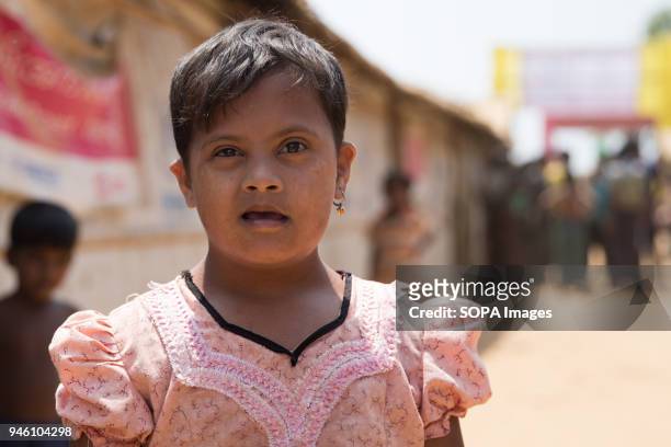 Young Rohingya girl with Down Syndrome poses for a photograph in Kutupalong refugee camp. There are now approximately 600,000 Rohingya refugees in...