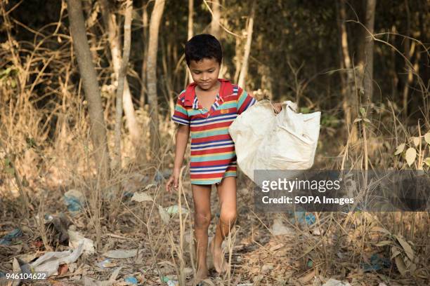 Young Rohingya boy walks through a wood of rubbish in Kutupalong refugee camp. There are now approximately 600,000 Rohingya refugees in the...