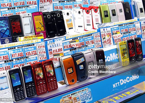 DoCoMo Inc.'s mobile phones are dysplayed at a store in Tokyo, Japan, on Friday, October 27, 2006. Japan's consumer price gains unexpectedly slowed,...