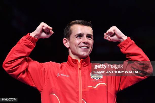 Gold medallist England's Peter McGrail celebrates during the medal ceremony for the men's 56kg boxing event during the 2018 Gold Coast Commonwealth...