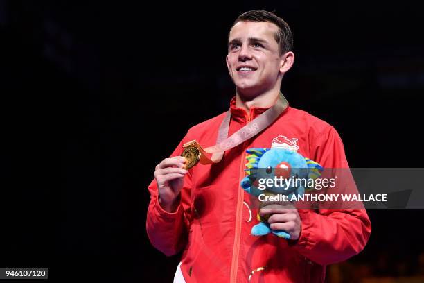 Gold medallist England's Peter McGrail celebrates during the medal ceremony for the men's 56kg boxing event during the 2018 Gold Coast Commonwealth...