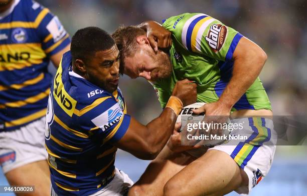 Michael Jennings of the Eels tackles Elliot Whitehead of the Raiders high during the round six NRL match between the Canberra Raiders and the...