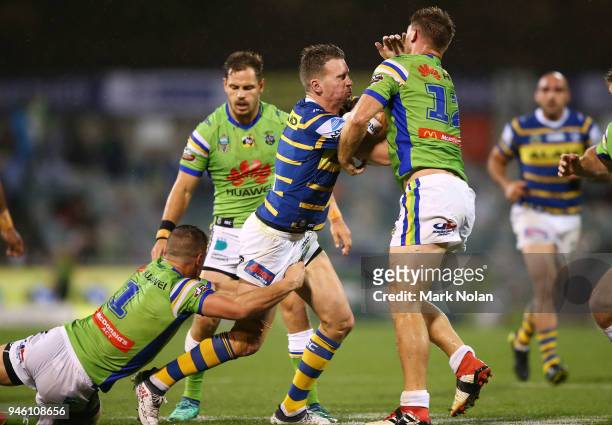 Clinton Gutherson of the Eels is tackled during the round six NRL match between the Canberra Raiders and the Parramatta Eels at GIO Stadium on April...