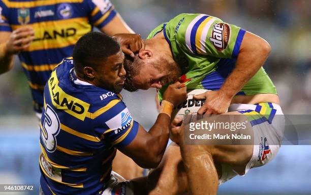 Michael Jennings of the Eels tackles Elliot Whitehead of the Raiders high during the round six NRL match between the Canberra Raiders and the...