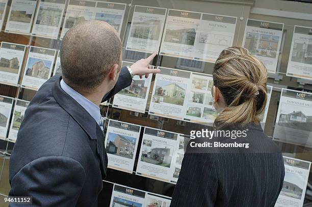 People look at advertisements in the window of Martin & Armitage Estate Agents, in Downham Market, Norfolk, U.K., on Tuesday, May 8, 2007. The Bank...