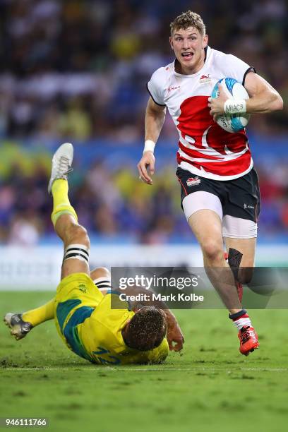 Ruaridh McConnochie of England beats the tackle of Lachlan Anderson of Australia on his way to score a try during the Rugby Sevens match between...