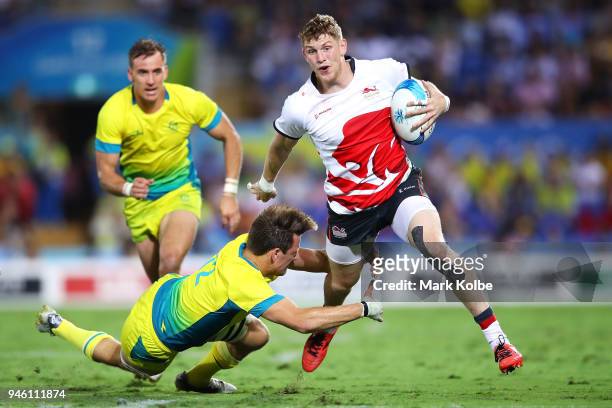 Ruaridh McConnochie of England beats the tackle of Lachlan Anderson of Australia on his way to score a try during the Rugby Sevens match between...
