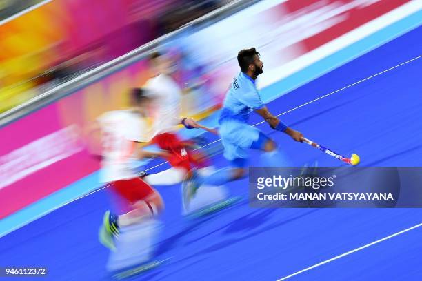 India's Manpreet Singh makes a run with the ball against England during their men's field hockey bronze medal match of the 2018 Gold Coast...