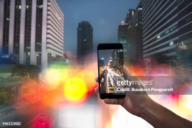 shooting light on road in the city at night with mobile phone - slow shutter stock pictures, royalty-free photos & images