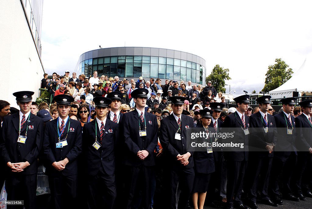 The crowds queue behind security guards waiting for the open