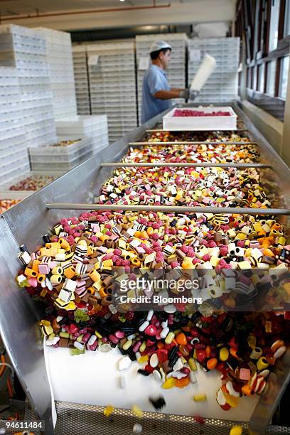 Gummi bears, licorice and candy strawberries come off the production line in the packing area at the Haribo candy factory in Bonn, Germany, Friday,...