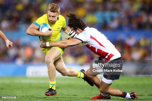 Ben O'Donnell of Australia is tackled during the Rugby Sevens match between Australia and England on day 10 of the Gold Coast 2018 Commonwealth Games...