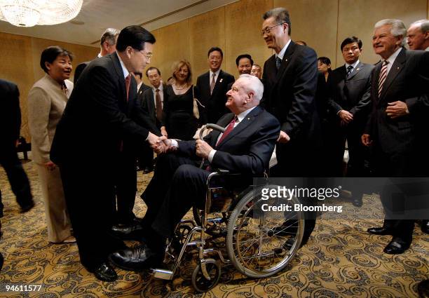 Hu Jintao, China's president, left, greets 90 year old former Australian Prime Minister Gough Whitlam, prior to a ministerial dinner on day four of...