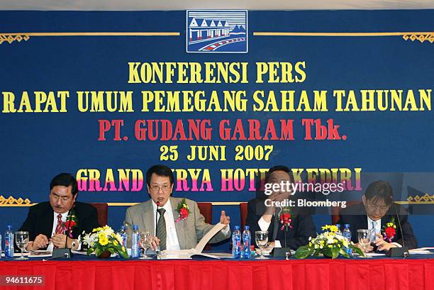 Gudang Garam Tbk Directors Djohan Harijono, left, and Heru Budiman, second left, are seated beside Marketing Director Widijanto, second right, and...