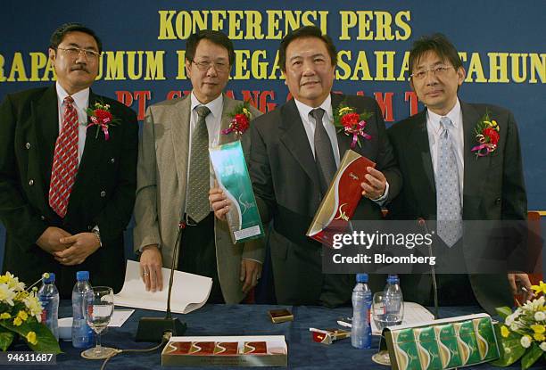 Gudang Garam Tbk Directors Djohan Harijono, left, and Heru Budiman, second left, stand alongside Marketing Director Widijanto, second right, and...