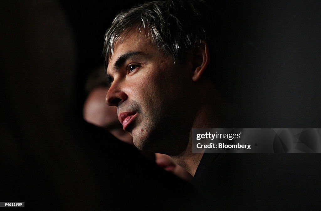 Larry Page, co-founder of Google Inc., listens as Bill Clint