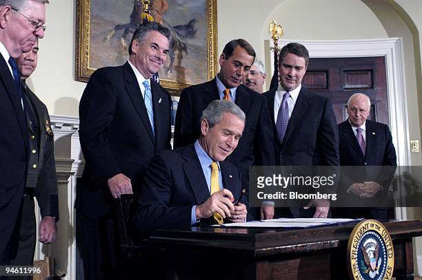 President George W. Bush signs the Secure Fence Act of 2006 during a Roosevelt Room ceremony at the White House, October 26, 2006 in Washington, D.C....