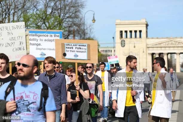 Girl with a sign asking for funding for their research. Some hundreds of people joined the March for Science in Munich, Germany, on 14 April 2018....