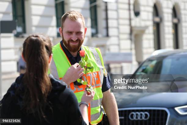 An activist gives a police officer a flower. Some hundreds of people joined the March for Science in Munich, Germany, on 14 April 2018. Among them...