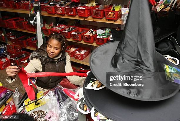 Shirley Martins, of London, sifts through costumes at Preposterous Presents novelty shop, in London, U.K., Thursday, October 26, 2006. U.K. Shops are...