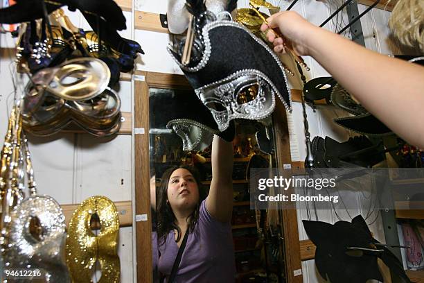Customer who refers to herself as Beck, 12 tries on a mask at Preposterous Presents novelty shop, in London, U.K., Thursday, October 26, 2006. U.K....