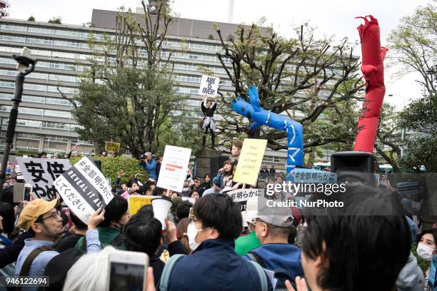 Protester holds a placard during a demonstration against the Japan's Prime Minister Shinzo Abe after allegations of corruption and calling him to...