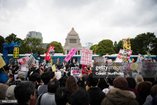 Protester holds a placard during a demonstration against Japan's Prime Minister Shinzo Abe after allegations of corruption, calling him to resign, on...