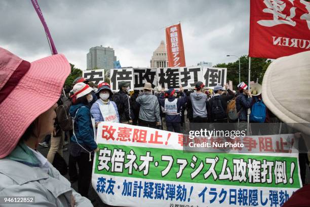 Protester holds a placard during a demonstration against Japan's Prime Minister Shinzo Abe after allegations of corruption, calling him to resign, on...