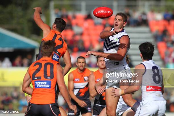 Aaron Sandilands of the Dockers knocks the ball out at the centre bounce during the round four AFL match between the Greater Western Sydney Giants...