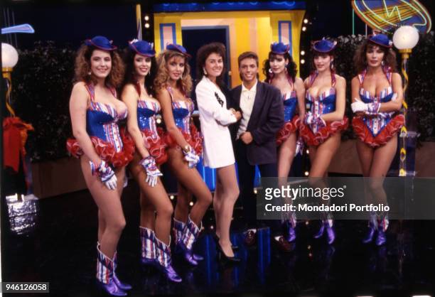 Lory Del Santo and Piersilvio Berlusconi posing among the fast food girls of the famous TV comic show 'Drive In' broadcasted by Italia 1. Milan , 1986