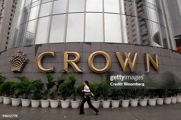 Pedestrian walks past the Crown Macau hotel and casino in Macau, China, on Friday, May 4, 2007. The Nasdaq-listed venture between Publishing &...