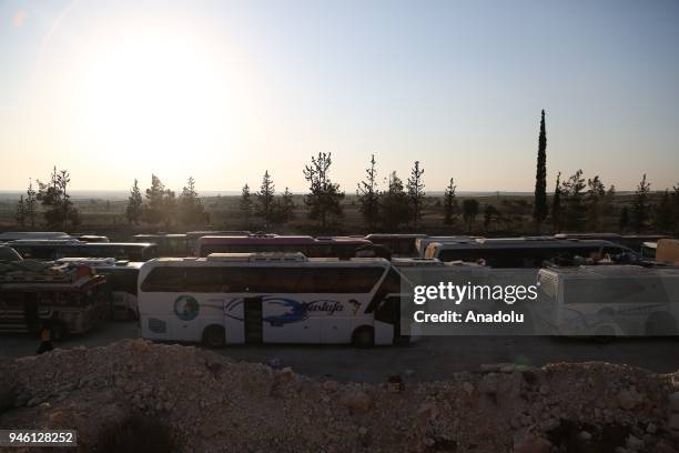 Syrian people from the city of Douma arrive in Al-Bab district of Aleppo, Syria on April 14, 2018. The 20th 85-bus convoy carrying civilians and...