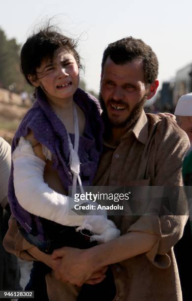 Syrian people from the city of Douma arrive in Al-Bab district of Aleppo, Syria on April 14, 2018. The 20th 85-bus convoy carrying civilians and...