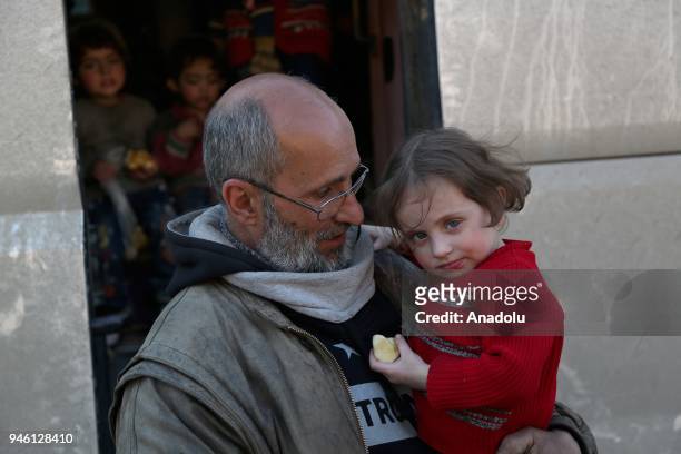 Syrian people from the city of Douma arrive in Al-Bab district of Aleppo, Syria on April 14, 2018. The 20th 85-bus convoy carrying civilians and...